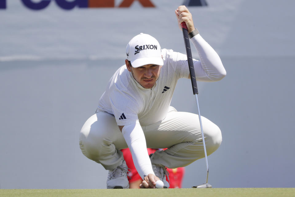 Alejandro Tosti places his ball on the 15th green before putting during the first round of the Houston Open golf tournament Thursday, March, 28, 2024, in Houston. (AP Photo/Michael Wyke)