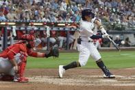 Milwaukee Brewers' Keston Hiura hits a home run during the ninth inning of a baseball game against the Cincinnati Reds Sunday, Aug. 7, 2022, in Milwaukee. (AP Photo/Morry Gash)
