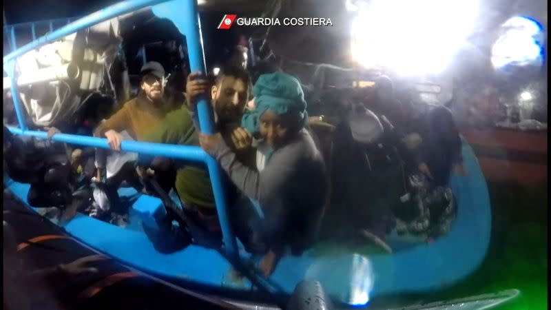 Italian coastguard rescue migrants from boat in distress in the Mediterranean Sea