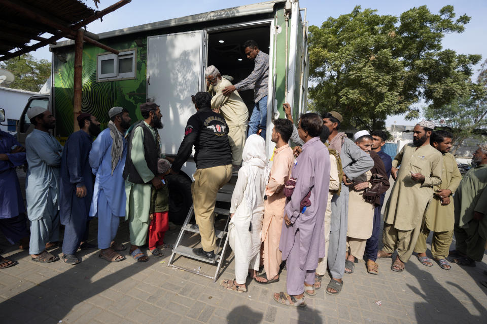 Immigrants, mostly Afghans, line up as they wait for their turn to verify data at a counter of Pakistan's National Database and Registration Authority in Karachi, Pakistan, Friday, Nov. 17, 2023. The U.N. health agency is warning that about 1.3 million Afghans are expected to return to Afghanistan from Pakistan where authorities earlier are expelling foreigners, mostly Afghans, living in the country illegally. It had forced at least 340,000 Afghans to leave Pakistan after spending decades, officials said Friday. (AP Photo/Fareed Khan)