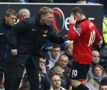 Manchester United manager David Moyes (L) talks to Wayne Rooney during their English Premier League soccer match against Everton at Goodison Park in Liverpool, northern England, April 20, 2014. REUTERS/Darren Staples