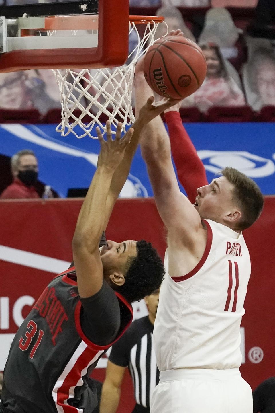 Wisconsin's Micah Potter stops a shot by Ohio State's Seth Towns during the second half of an NCAA college basketball game Saturday, Jan. 23, 2021, in Madison, Wis. (AP Photo/Morry Gash)