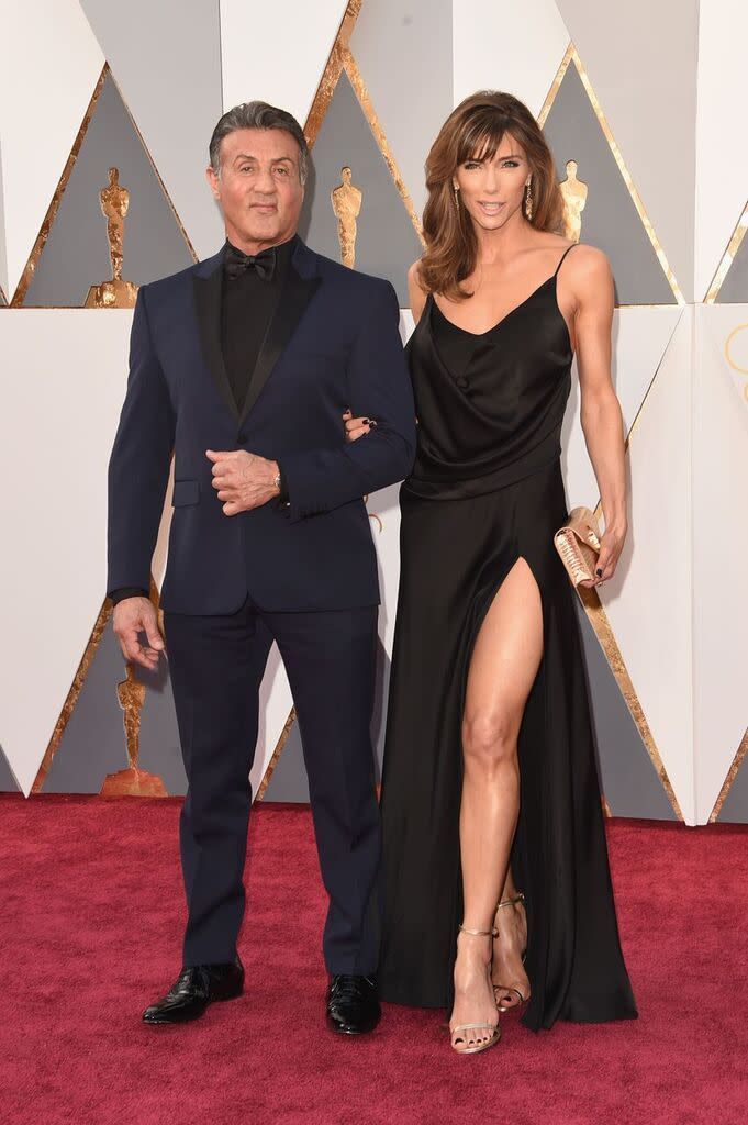 <p>The legendary actor wore a slim-fit (muscle-accentuating) midnight blue tuxedo with black accessories. And his wife, Jennifer Flavin — wowza! </p>