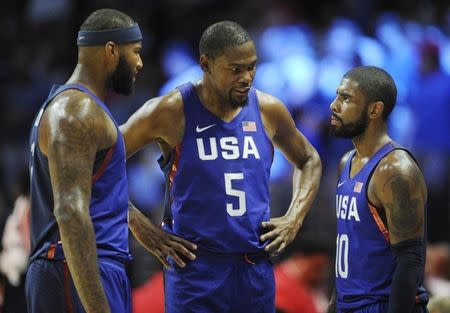 July 24, 2016; Los Angeles, CA, USA; USA guard Kevin Durant (5) speaks with center DeMarcus Cousins (left) and guard Kyrie Irving (right) before game action against China in the first half during an exhibition basketball game at Staples Center. Mandatory Credit: Gary A. Vasquez-USA TODAY Sports