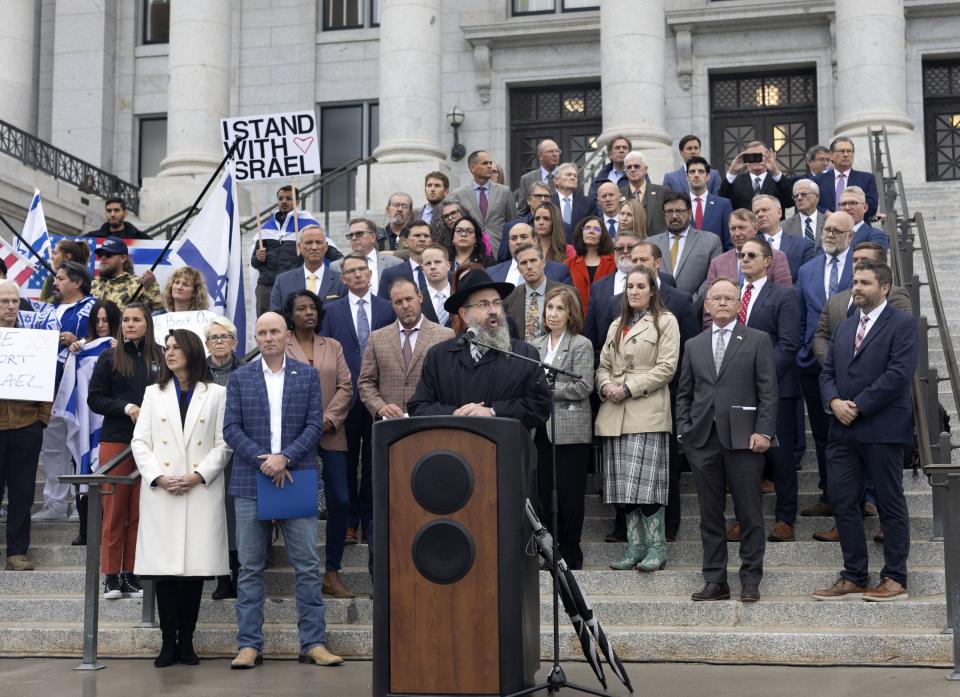 Utah legislators stand with Rabbi Benny Zippel, executive director of Chabad of Utah, as he speaks at the Stand with Israel rally at the Capitol in Salt Lake City on Oct. 11, 2023.