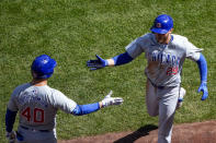 Chicago Cubs' Michael Busch, right, greets Mike Tauchman (40) after hitting a two-run home run against the Seattle Mariners during the fourth inning of a baseball game Sunday, April 14, 2024, in Seattle. (AP Photo/Lindsey Wasson)
