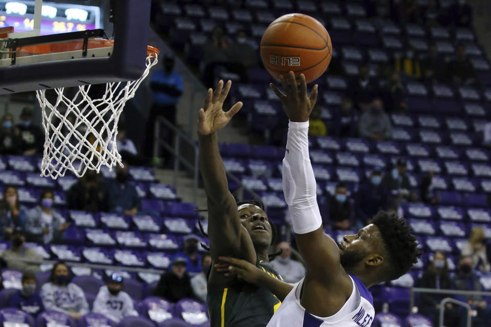 Baylor forward Jonathan Tchamwa Tchatchoua (23) tries to defend against a shot by TCU guard Mike Miles (1) in the first half of an NCAA college basketball game, Saturday, Jan. 9, 2021, in Fort Worth, Texas. (AP Photo/ Richard W. Rodriguez)