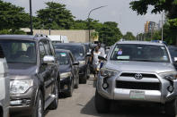 Motorists queue to buy fuel at a petrol station in Lagos Nigeria, Tuesday, May 30, 2023. Nigerian President Bola Tinubu has scrapped a decadeslong government-funded subsidy that has helped reduce the price of gasoline, leading to long lines at fuel stations Tuesday as drivers scrambled to stock up before costs rise. (AP Photo/Sunday Alamba)