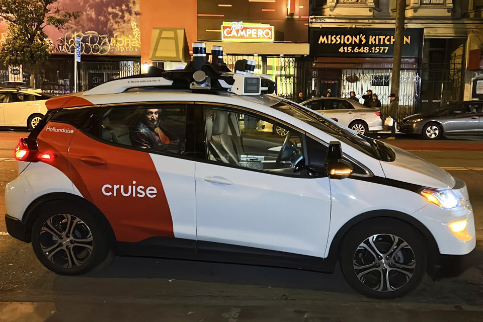 Associated Press reporter Michael Liedtke sits in the back of a Cruise driverless taxi that picked him up in San Francisco's Mission District, Feb. 15, 2023. 