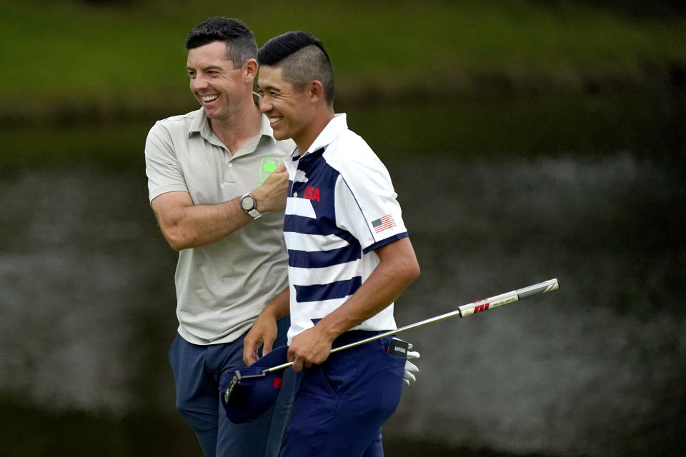 Rory McIlroy, of Ireland, left, and Collin Morikawa, of the United States, laugh after the first round of the men's golf event at the 2020 Summer Olympics, Thursday, July 29, 2021, at the Kasumigaseki Country Club in Kawagoe, Japan, (AP Photo/Matt York)