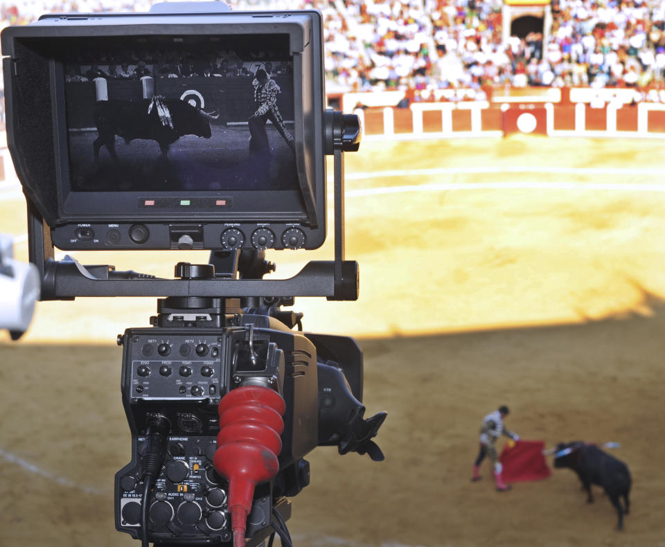 A TV camera films during a bullfight in Valladolid, Spain Wednesday Sept. 5, 2012. Bullfights returned live to Spanish state TV Wednesday evening, six years after the fights were banned from the widely watched public channel with the broadcast featuring one of Spain’s most storied bullfighters and giving a boost to a tradition hit hard by declining popularity and a dire economic crisis. The RTVE broadcast from the northern city of Valladolid is a big victory for pro-bullfighting forces that saw bullfighting banned altogether this year in the northeastern region of Catalonia; it’s a defeat for animal rights activists who denounce bullfighting as barbaric. The transmissions were halted in 2006 by Spain’s previous Socialist administration, which said they were costly and coincided with key TV viewing hours for young children. (AP Photo/Israel L. Murillo)