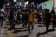 Migrants walk along a street in a caravan towards the United States, in Tapachula