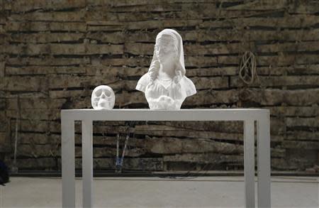 Chinese artist Li Hongbo's paper sculptures are placed on a table for a photo at his studio on the outskirts of Beijing, January 20, 2014. REUTERS/Jason Lee