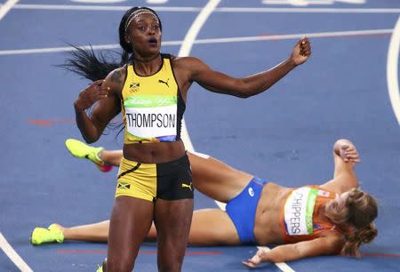 2016 Rio Olympics - Athletics - Final - Women's 200m Final - Olympic Stadium - Rio de Janeiro, Brazil - 17/08/2016. First placed Elaine Thompson (JAM) of Jamaica reacts in front of second placed Dafne Schippers (NED) of Netherlands. REUTERS/David Gray