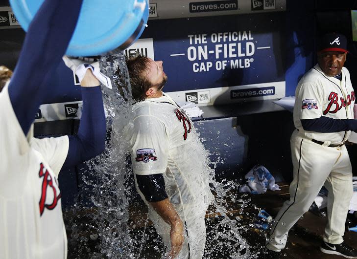 A.J. Pierzynski, center, is doused with water by teammate Freddie Freeman after the Braves beat Mets 4-3. (AP)