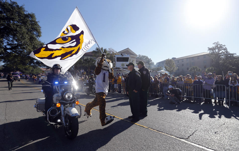 The LSU mascot Mike the Tiger runs down the road outside Tiger Stadium before an NCAA college football game against Arkansas in Baton Rouge, La., Saturday, Nov. 11, 2017. (AP Photo/Gerald Herbert)