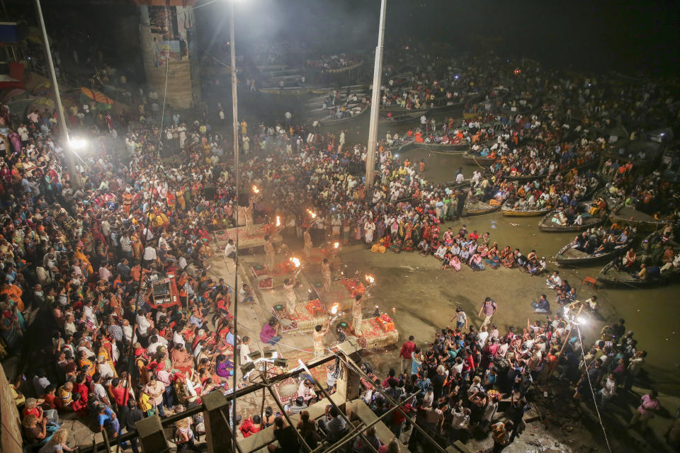 A crowd gathers for a prayer ceremony dedicated to the river Ganges in Varanasi, one of the Hinduism's holiest cities, India, Thursday, Oct. 17, 2019. For millions of Hindus, Varanasi is a place of pilgrimage and anyone who dies in the city or is cremated on its ghats is believed to attain salvation and freed from the cycle of birth and death. Some of the world's largest religious congregations are marked in Varanasi, a city along the River Ganges, also known as one of the oldest continuously inhabited in the world. (AP Photo/Altaf Qadri)