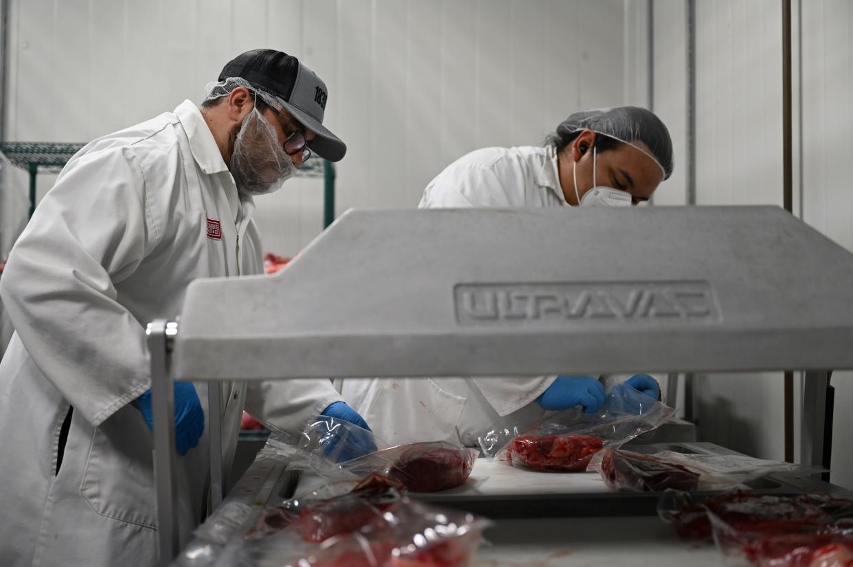 Workers process meat at 1839 Cherokee Meat Co.