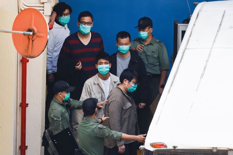 Pro-democracy activists Sam Cheung, Lam Cheuk-ting, Raymond Chan Chi-chuen and Owen Chow walk to a prison van to head to court, over national security law charges, in Hong Kong