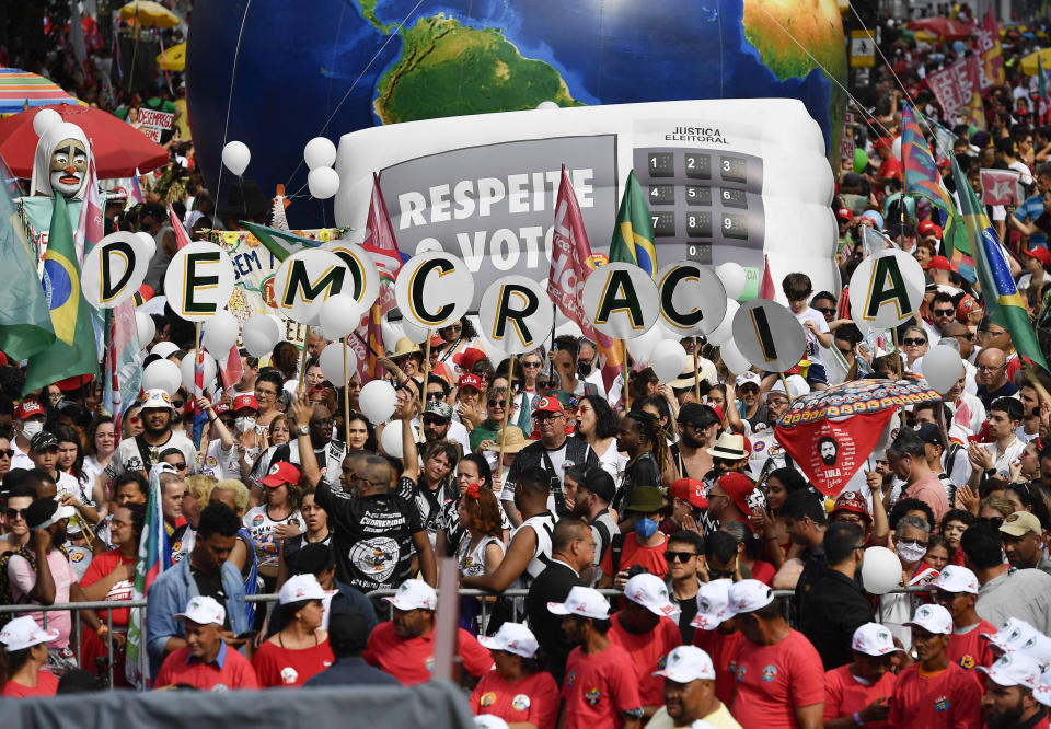 Supporters of former President Luiz Inacio Lula da Silva, who is running for the presidency again, gather for a campaign rally in Sao Paulo, Brazil, Saturday, Oct. 29, 2022. On Sunday, Brazilians head to the voting booth again to choose between da Silva and incumbent Jair Bolsonaro, who are facing each other in a runoff vote after neither got enough support to win outright in the Oct. 2 general election. (AP Photo/Matias Delacroix)