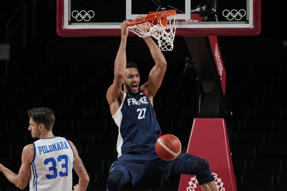 France's Rudy Gobert (27) scores over Italy's Achille Polonara (33) during a men's basketball quarterfinal round game at the 2020 Summer Olympics, Tuesday, Aug. 3, 2021, in Saitama, Japan. (AP Photo/Eric Gay)