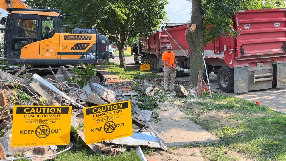 Crews work to demolish an abandoned home on Eastlawn Street in Detroit, Mi on July 20, 2021. Georgia Taylor fought for seven years to get the abandoned home next door demolished and she now owns the lot.