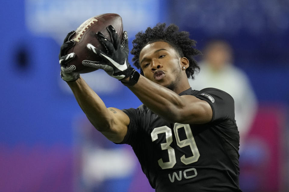 FILE - Ohio State wide receiver Garrett Wilson catches a pass during a drill at the NFL football scouting combine, Thursday, March 3, 2022, in Indianapolis. Wilson is a possible first round pick in the NFL Draft. (AP Photo/Charlie Neibergall, File)