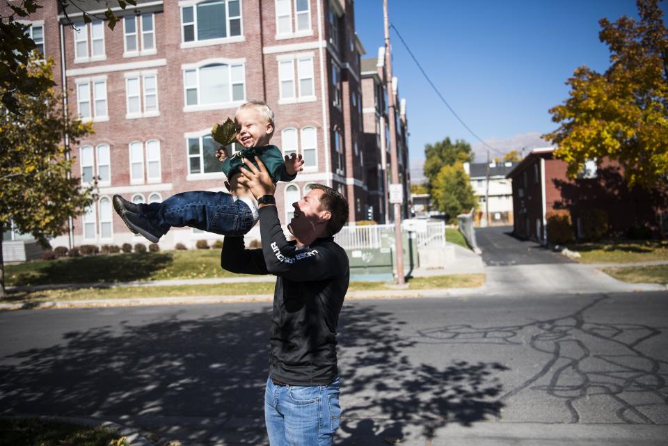 Nick Schaffer plays with Max while his mother, Sarah Hess, is interviewed.