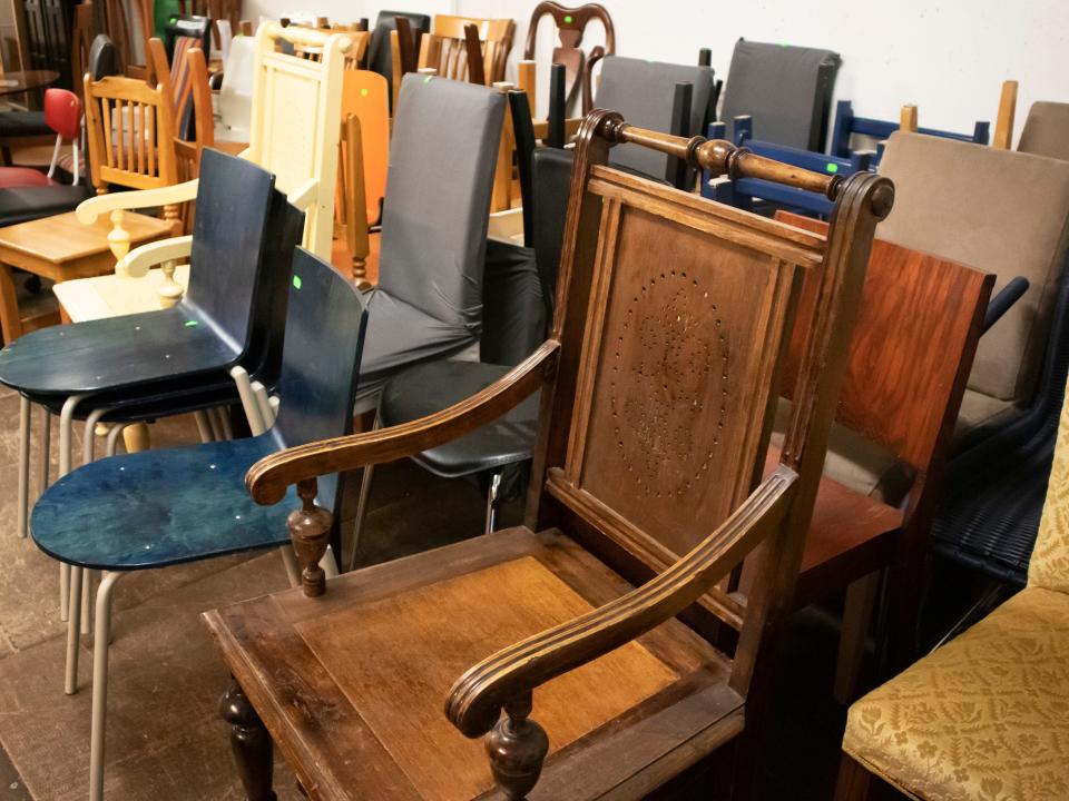 Wooden chairs with other school chairs and fabric-covered chair