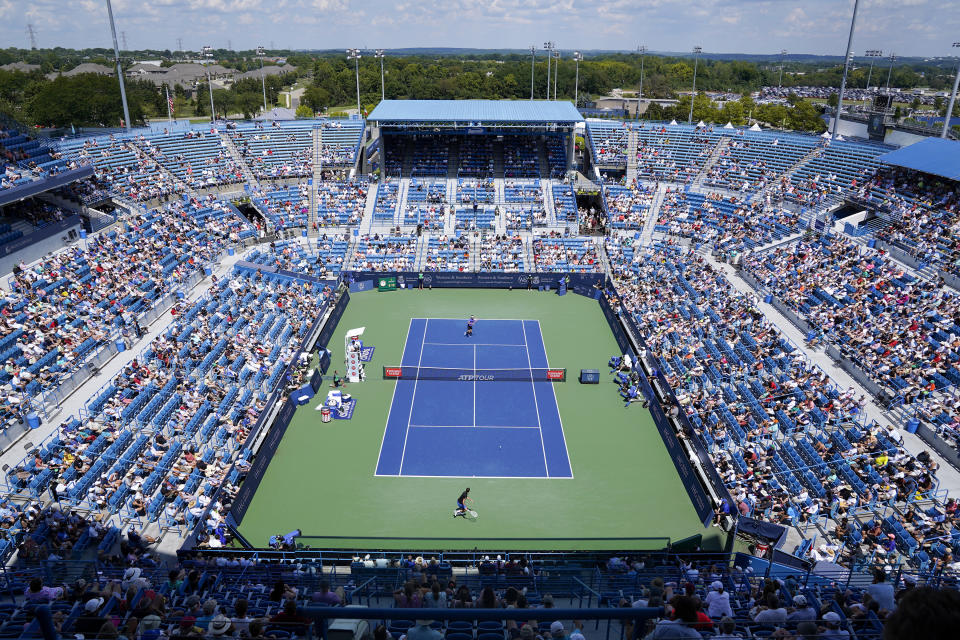 Daniil Medvedev, bottom, of Russia, moves to return a shot to Taylor Fritz, of the United States, during a quarterfinal match at the Western & Southern Open tennis tournament Friday, Aug. 19, 2022, in Mason, Ohio. (AP Photo/Jeff Dean)