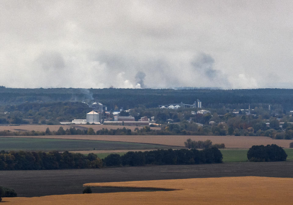 Smoke rises after a powerful explosion at the ammunition depot of a military base near the town of Ichnya, about 170 km (110 mile) east of Kiev Ukraine, early Tuesday, Oct. 9, 2018. More than 10,000 residents have been evacuated after an ammunition depot exploded early Tuesday. (Vlad Musienko /Prime Minister Service Pool Photo via AP)