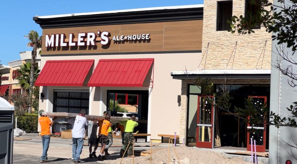 Construction workers carry a bar countertop into the Miller's Ale House restaurant nearing completion at the Altamira Village shopping center just east of the Interstate 95/Dunlawton Avenue interchange (Exit 256) in Port Orange on Monday, Oct. 30, 2023. The eatery is on track to open in early December.