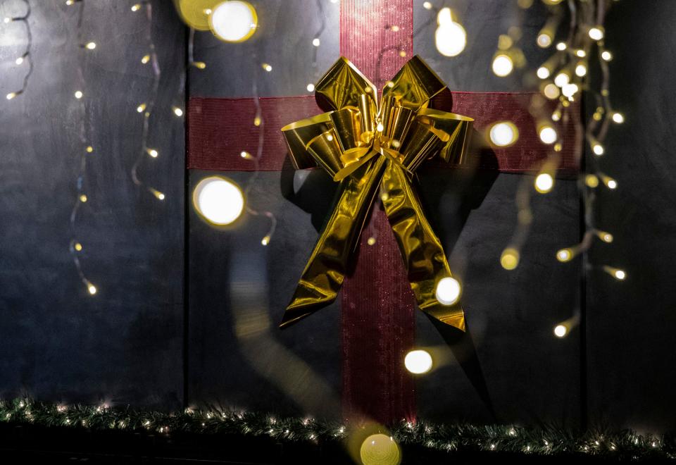 A gift wrapped panel is seen on the wall as a part of the holiday decorations at Truss & Twine in celebration of their Miracle pop-up bar collaboration in Palm Springs, Calif., Friday, Nov. 24, 2023.