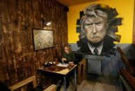 A visitor has a meal at Trump Burger, a new Russian diner named after U.S. President Donald Trump, in Krasnoyarsk, Russia July 17, 2018. Picture taken July 17, 2018. REUTERS/Ilya Naymushin