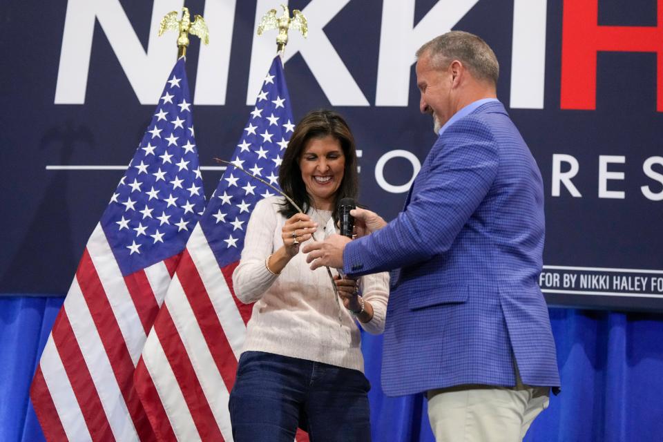 Republican South Carolina Rep. Chris Wooten, right, hands a switch to Republican presidential candidate former UN Ambassador Nikki Haley on Monday, Feb. 19, 2024, in Greer, S.C. (AP Photo/David Yeazell) ORG XMIT: SCDY800