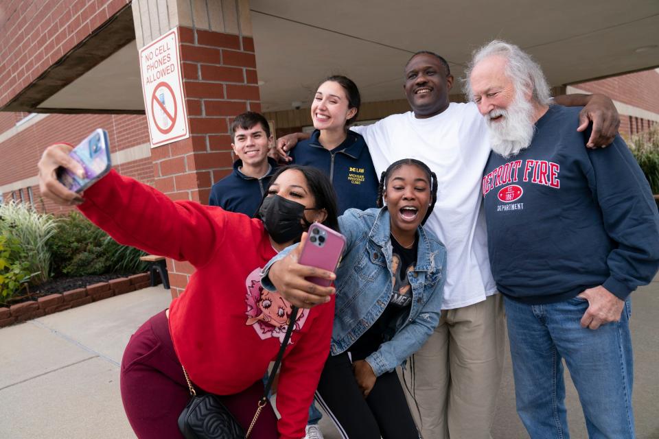 Shanae Kyles, 30, of Pontiac (red) and her sister Amera Alexander, 26, of Detroit (jean jacket) do selfies with University of Michigan student attorneys Elijah Ayala and Micayla Brugellis as they pose with Anthony Kyles, 54, who was released from the Carson City Correctional Facility Wednesday, Oct, 12, 2022. In 1997, a jury convicted Kyles of four counts of second-degree murder. The prosecution's theory was Kyles set the fire by throwing a Molotov cocktail at the house, killing three children and their father. Jurors heard that Kyles feuded with the children's mother over drugs, that he wanted to show he was in charge and that a witness saw him start the fire on the porch area. The witness has since recanted, saying he lied to the jury. Robert Trenkle, far left, who is a fire expert and investigator, concluded that the fire wasn't deemed arson.