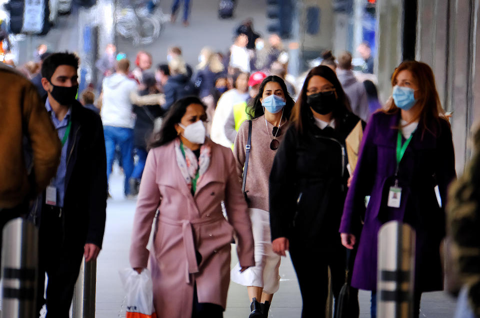 People wearing face masks walk in the Melbourne CBD. Source: AAP