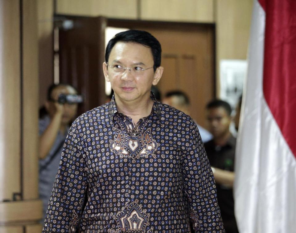 Jakarta Governor Basuki Tjahaja Purnama, popularly known as "Ahok," walks inside a court room for his trial at North Jakarta District Court in Jakarta, Indonesia, Tuesday, Dec. 27, 2016. Ahok is on trial for blasphemy following his remark about a passage in the Quran that could be interpreted as prohibiting Muslims from accepting non-Muslims as leaders. (Bagus Indahono/Pool Photo via AP)