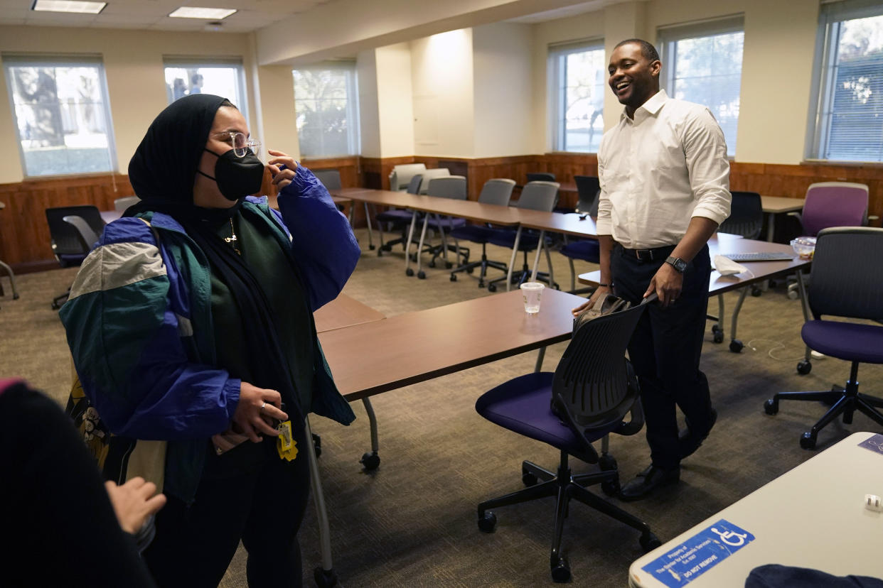 Texas Christian University assistant professor of literature Brandon Manning, right, shares a laugh with a student after seminar class at TCU campus in Fort Worth, Texas, Tuesday, Feb. 15, 2022. Manning was born in the U.S. South and had been itching to return there, but Manning didn't want to go back to his native Atlanta because of the traffic, cost of housing and sprawl. The largest African American growth in pure numbers over the last decade didn't take place in the Black meccas of Atlanta or Houston, but rather smaller cities with lower profiles: Fort Worth; Columbus, Ohio; Jacksonville, Florida; and Charlotte, North Carolina. (AP Photo/LM Otero)