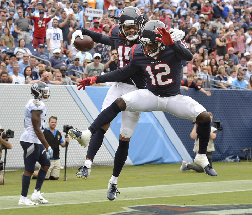 Houston Texans wide receiver Will Fuller (15) celebrates with Bruce Ellington (12) after Fuller scored a touchdown against the Tennessee Titans in the second half of an NFL football game Sunday, Sept. 16, 2018, in Nashville, Tenn. (AP Photo/Mark Zaleski)