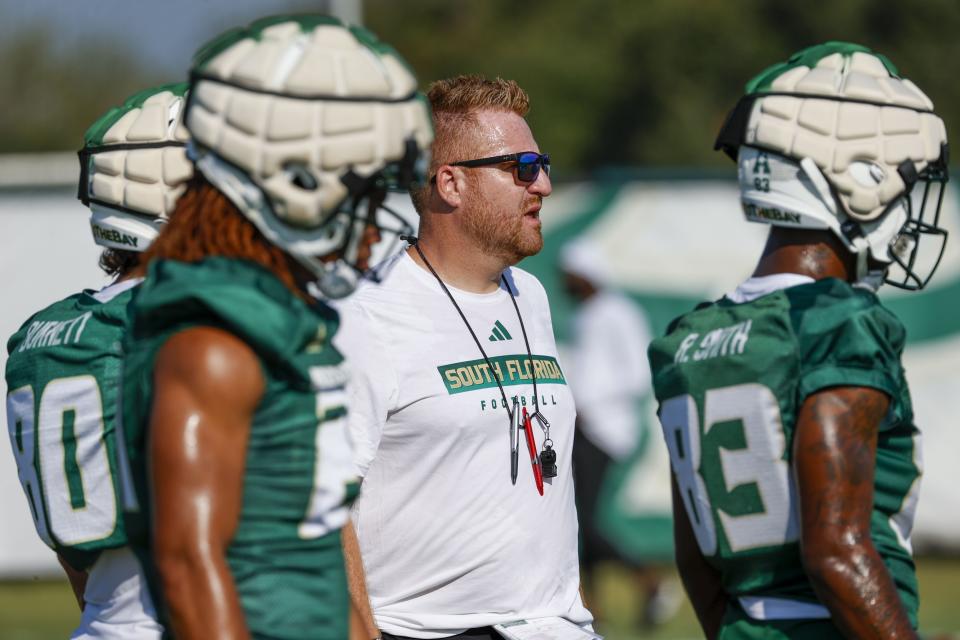 University of South Florida NCAA college football head coach Alex Golesh looks on during the first day of fall practice on a field near the Porter Family Performance Facility on the USF campus in Tampa, Fla., Wednesday, Aug. 2, 2023. The University of South Florida is looking for some big changes when the school plans to open a new $340 million on-campus football stadium in 2026. They say it’ll be easier for students to access, become a focal point for alumni and school benefactors, improve football recruitment and possibly propel the Bulls into a major conference. (Ivy Ceballo/Tampa Bay Times via AP)