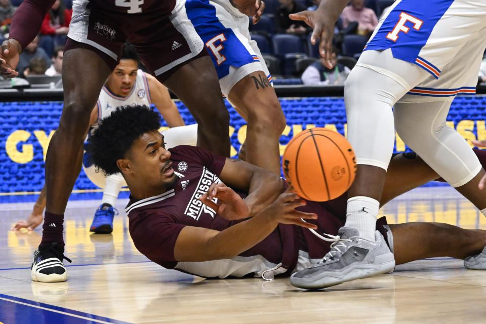 Mississippi State forward Tolu Smith (1) passes from the floor during the first half of an NCAA college basketball game against Florida in the second round of the Southeastern Conference Tournament, Thursday, March 9, 2023, in Nashville, Tenn.(AP Photo/John Amis)