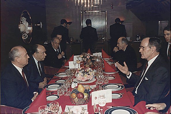 Soviet leader Mikhail Gorbachev (L) and U.S. President George H.W. Bush (R) eat dinner during a summit December 2, 1989, in Malta. On December 3, the two leaders declared an end to the Cold War. File Photo by David Valdez/U.S. president's office