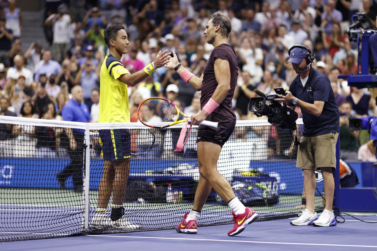 Rafael Nadal (R) of Spain shakes hands with Rinky Hijikata (L) of Australia after defeating him in their Men's Singles First Round match on Day Two of the 2022 U.S. Open at USTA Billie Jean King National Tennis Center on Aug. 30, 2022, in Flushing, Queens.