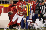 Kansas City Chiefs quarterback Patrick Mahomes (15) runs past Denver Broncos linebacker Bradley Chubb (55) during the first half of an NFL football game Sunday, Dec. 5, 2021, in Kansas City, Mo. (AP Photo/Charlie Riedel)