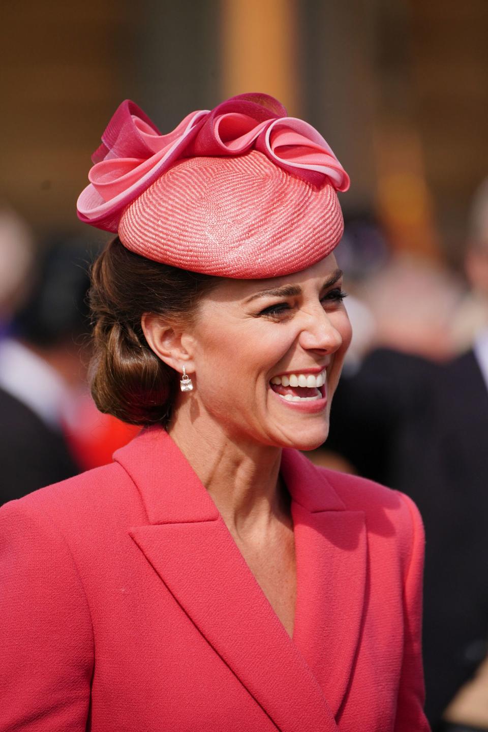 The Duchess of Cambridge smiles as she speaks to guests at a Royal Garden Party 