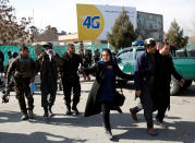 <p>Afghan security forces members and civilians assist the injured after a blast in Kabul, Afghanistan , Jan. 27, 2018. (Photo: Mohammad Ismail/Reuters) </p>