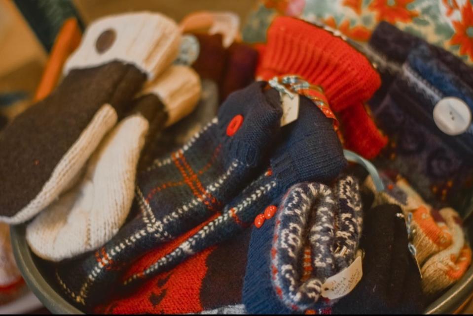 Handmade mittens made from repurposed sweaters are displayed at a past year's Beautiful Land Holiday Market.