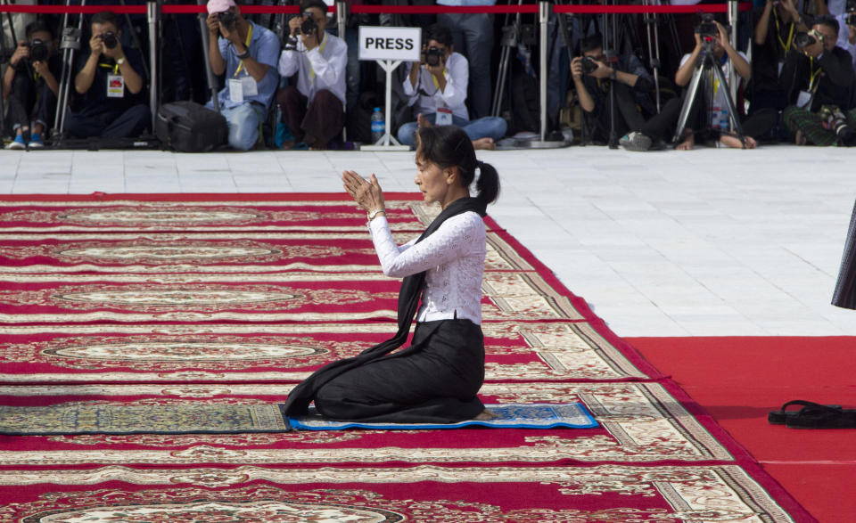 Myanmar leader Aung San Suu Kyi prays at the tomb of her late father and Myanmar's independence hero Gen. Aung San during a ceremony to mark the 72nd anniversary of his 1947 assassination, at the Martyrs' Mausoleum Friday, July 19, 2019, in Yangon, Myanmar. The country's Independence hero Gen. Aung San and his cabinet were gunned down in 1947. (AP Photo/Thein Zaw)