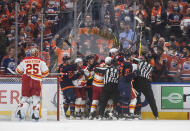 Calgary Flames and Edmonton Oilers scuffle during the first period of an NHL hockey game Saturday, Oct. 16, 2021, in Edmonton, Alberta. (Jason Franson/The Canadian Press via AP)